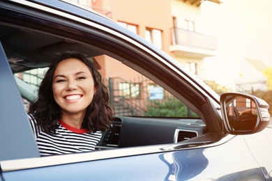 Photo of Young beautiful woman sitting in family car outdoors