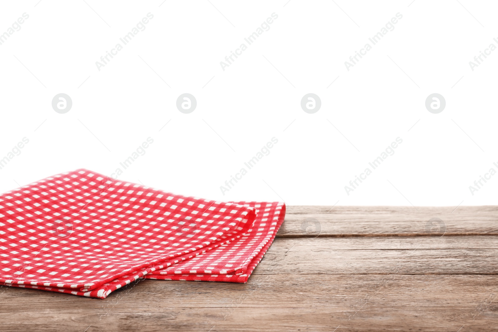 Photo of Red checkered napkins on wooden table against white background. Mockup for design