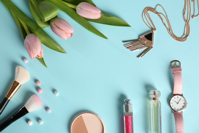Photo of Flat lay composition with flowers and different beauty accessories on color background, space for text