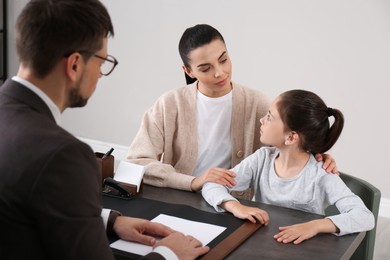 Photo of Mother and daughter having meeting with principal at school