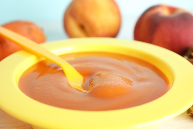 Photo of Baby food in bowl and fresh ingredients, closeup