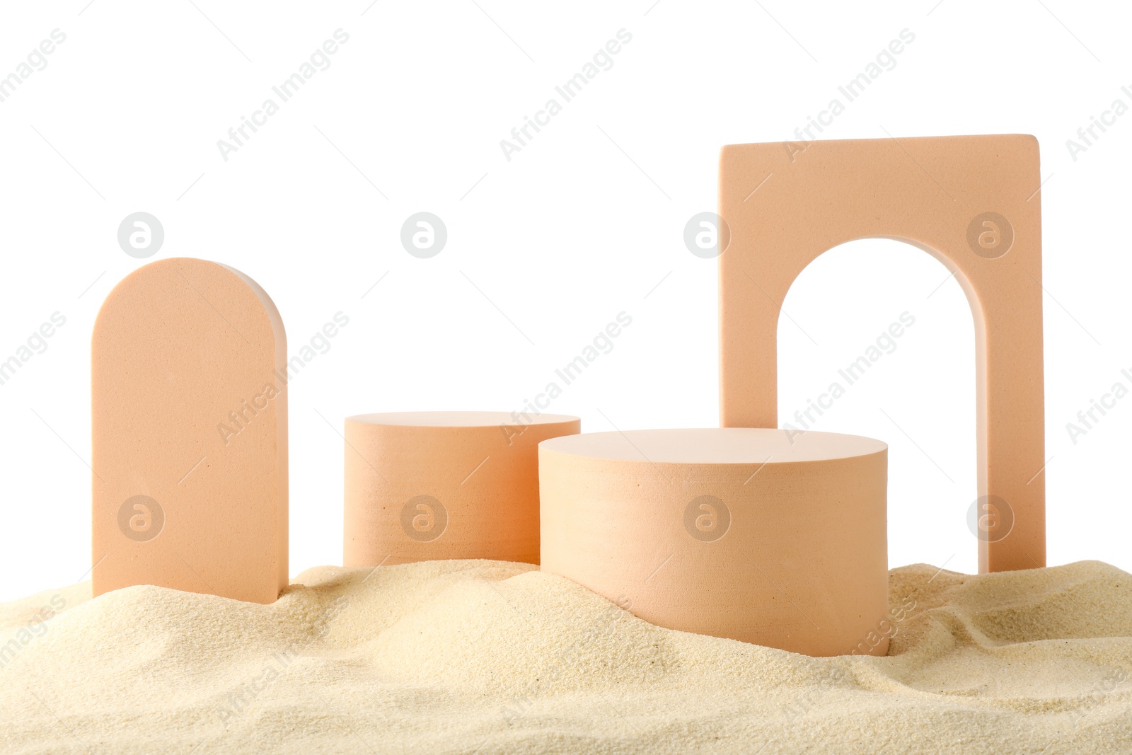 Photo of Presentation of product. Different podiums on sand against white background