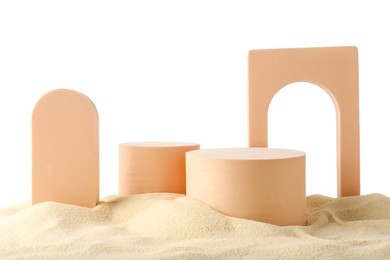 Photo of Presentation of product. Different podiums on sand against white background