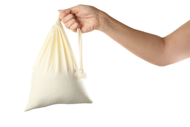 Photo of Woman holding full cotton eco bag on white background, closeup