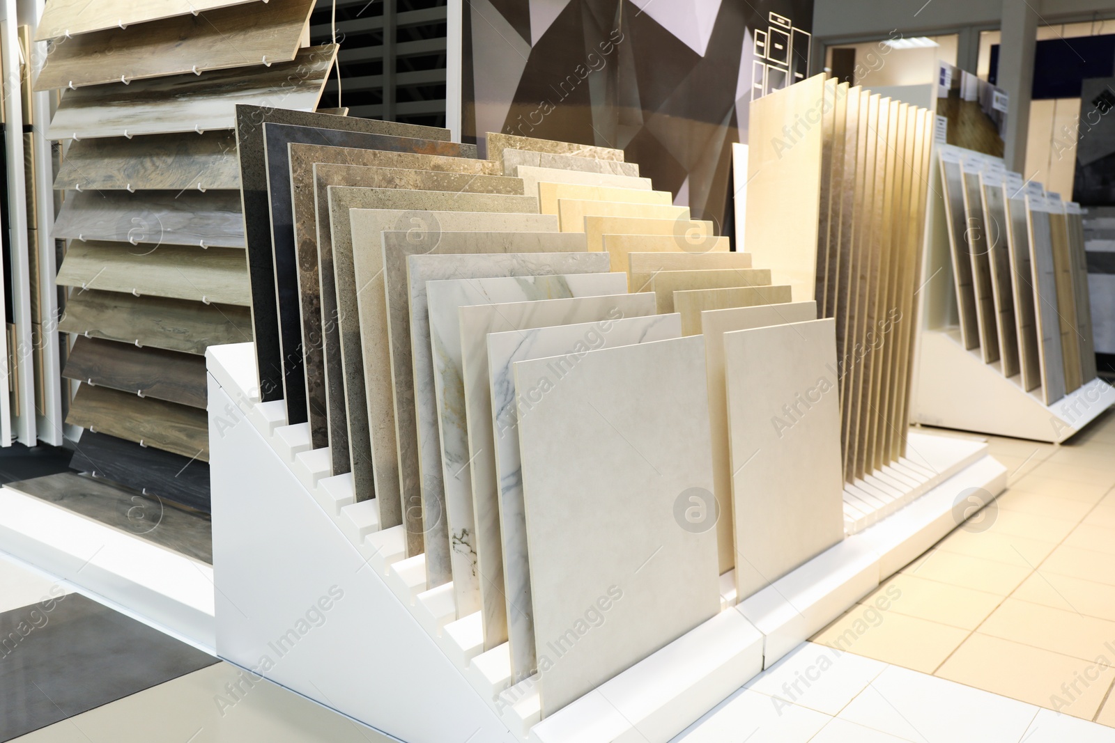 Photo of Assortment of tiles in store. Many different samples indoors