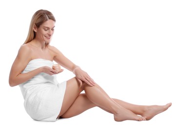 Woman applying body cream onto her leg against white background