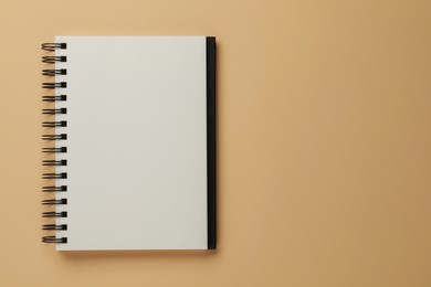 Photo of Blank notebook on beige background, top view. Space for text