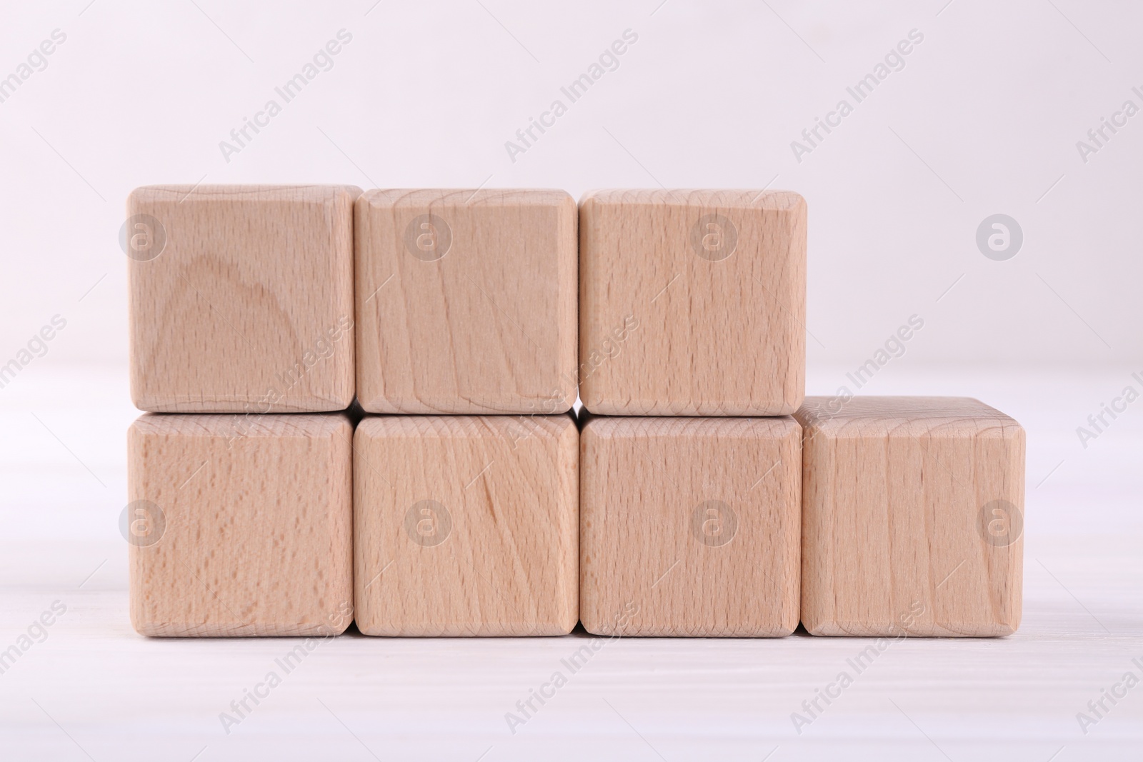 Photo of International Organization for Standardization. Cubes with abbreviation ISO and number 9001 on white table, closeup