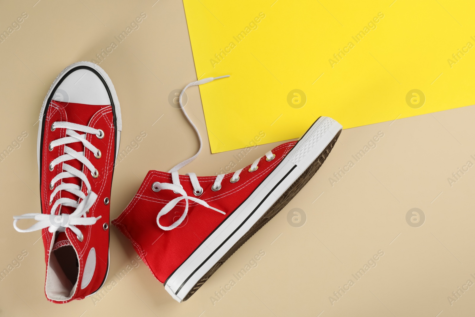 Photo of Stylish sneakers on color background, flat lay. Space for text