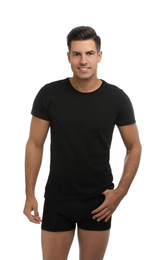 Handsome man in black underwear and t-shirt on white background