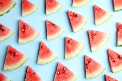 Photo of Watermelon slices on light blue background, flat lay