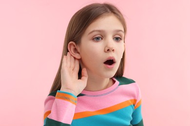 Photo of Little girl with hearing problem on pink background