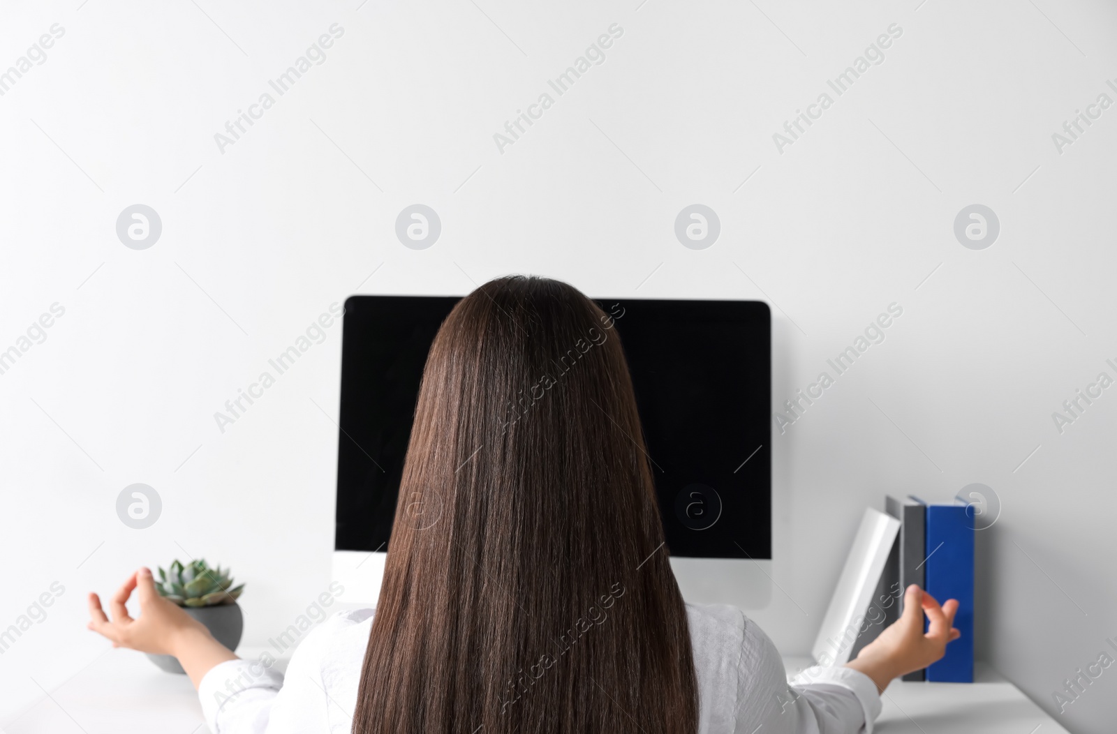 Photo of Find zen. Woman taking break from work indoors, back view