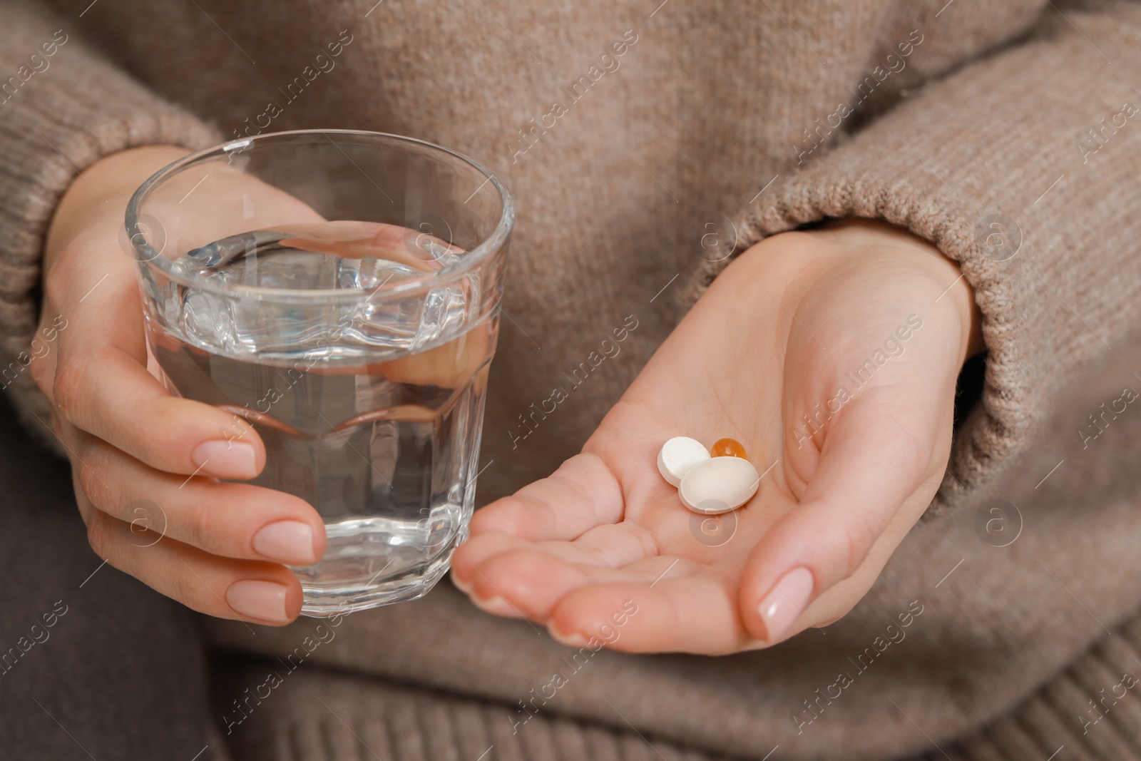 Photo of Woman with glass of water and pills, closeup