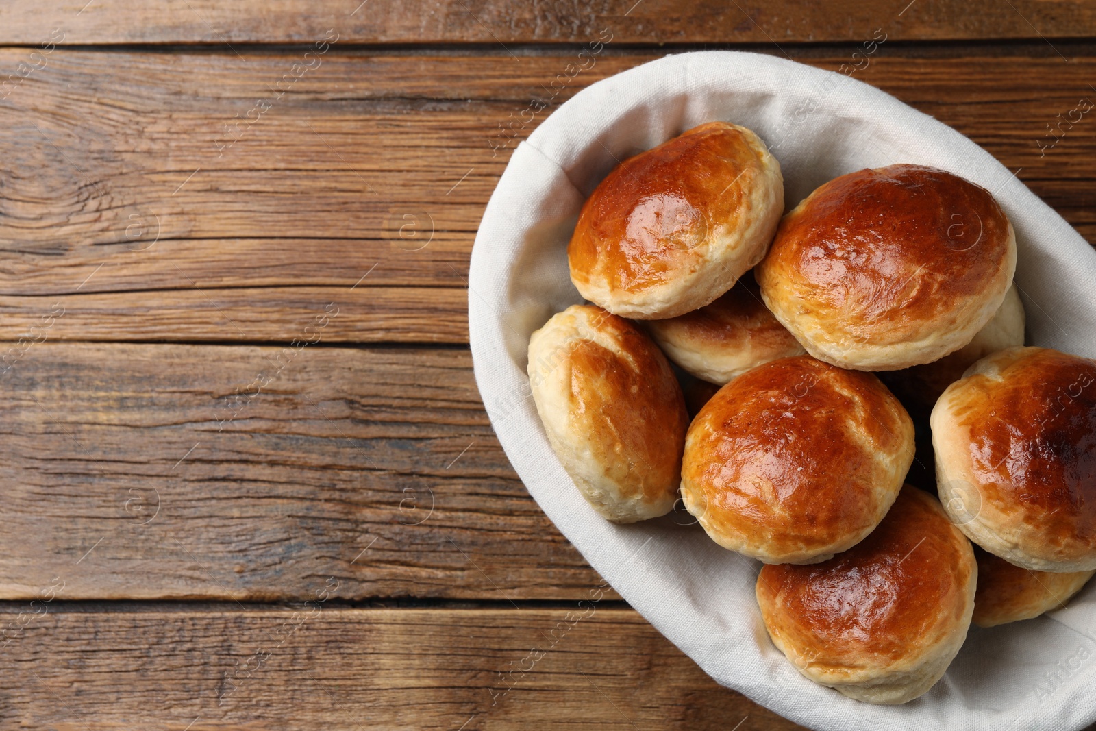 Photo of Tasty scones prepared on soda water on wooden table, top view. Space for text