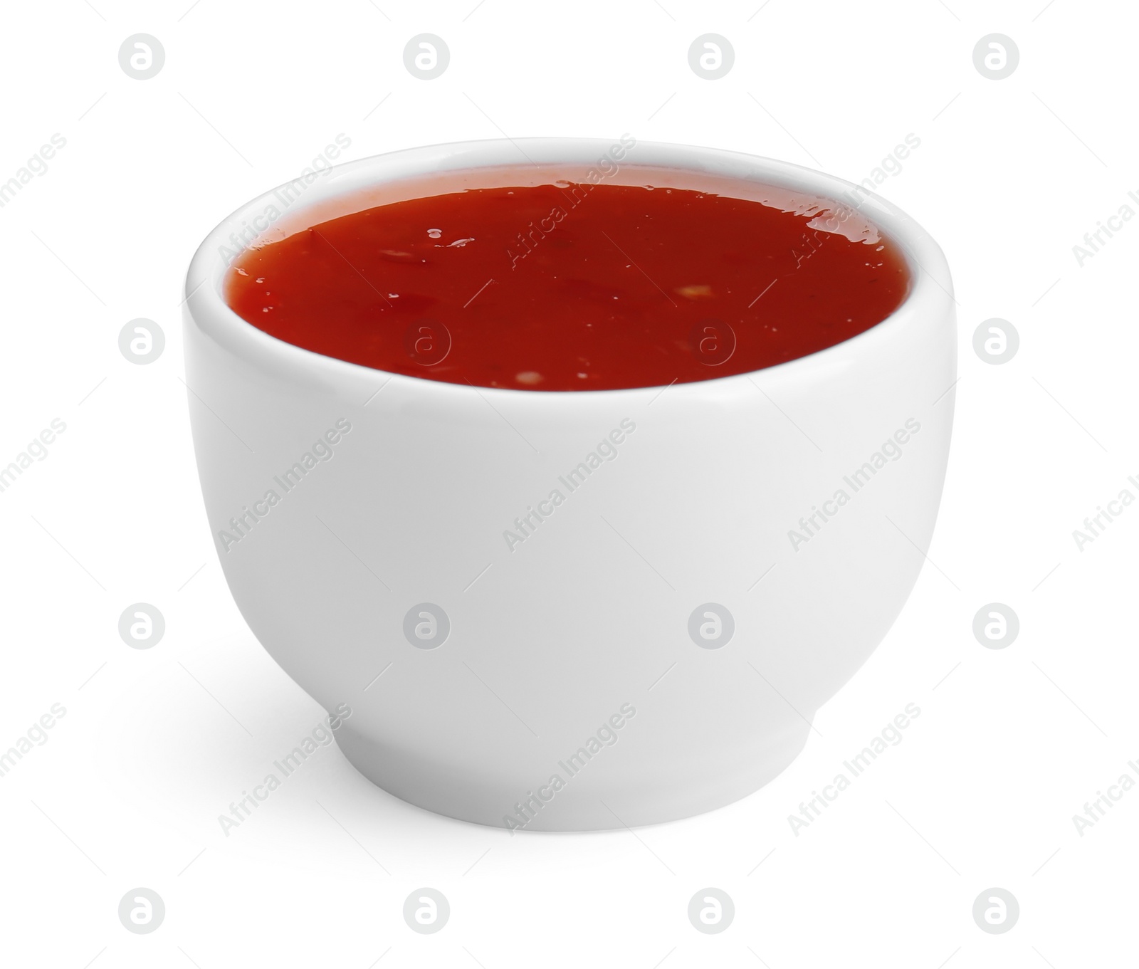 Photo of Spicy chili sauce in bowl isolated on white