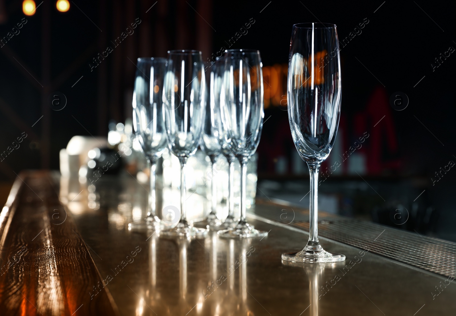 Photo of Empty clean champagne glasses on counter in bar