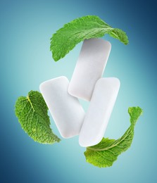 Image of Fresh mint leaves and chewing gum pads flying on light blue background