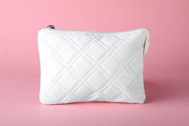 Photo of White leather cosmetic bag on pink background