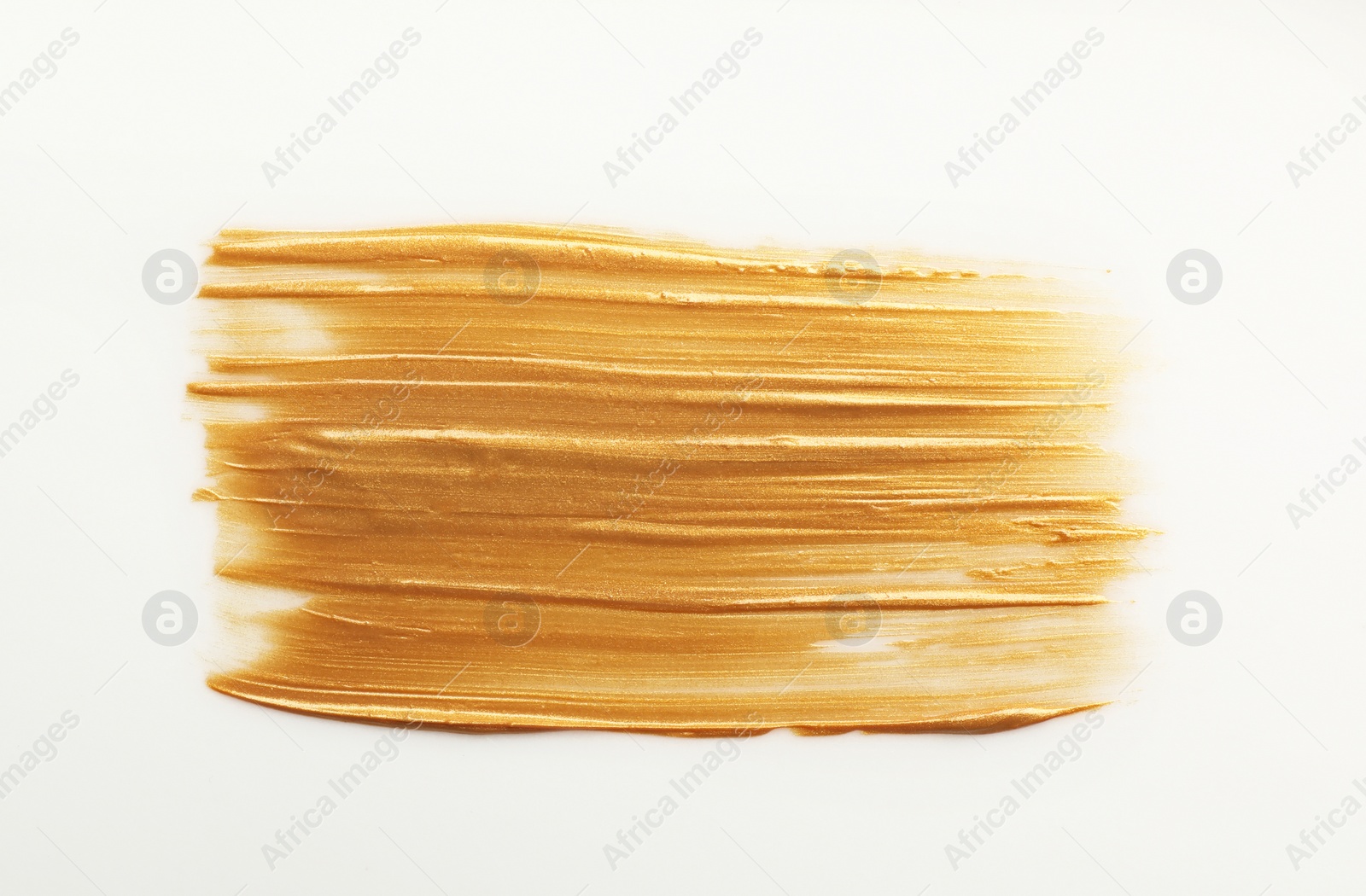 Photo of Stroke of gold paint isolated on white, top view