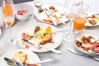 Photo of Food leftovers after party on table with cloth