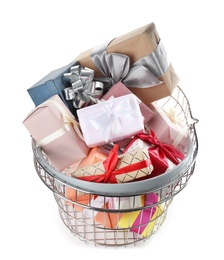 Photo of Shopping basket full of gift boxes on white background