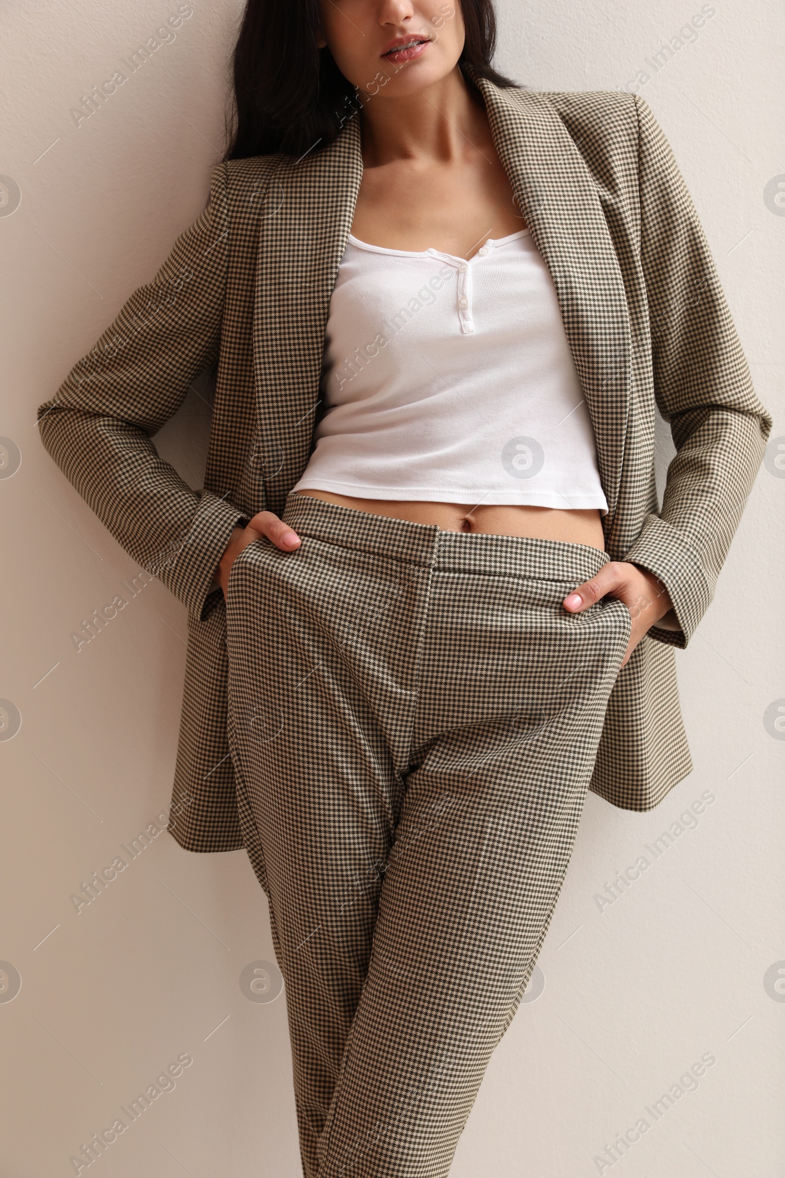 Photo of Woman in formal suit on light background, closeup. Business attire