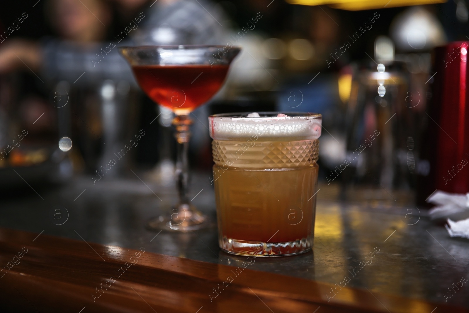 Photo of Glasses of tasty cocktails on bar counter