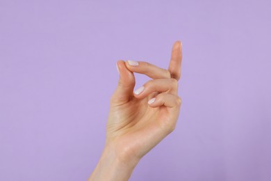 Photo of Woman snapping fingers on violet background, closeup of hand