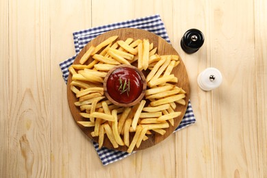 Photo of Delicious french fries served with ketchup on wooden table, flat lay