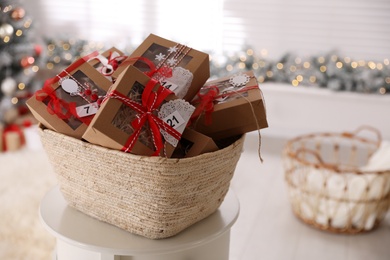 Basket full of gift boxes for Christmas advent calendar in room