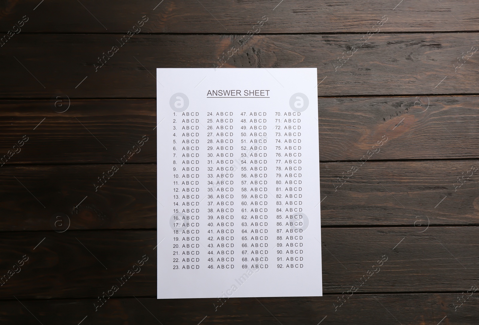 Photo of Answer sheet on wooden background, top view