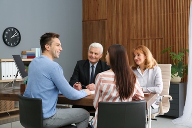 Lawyers having meeting with young couple in office