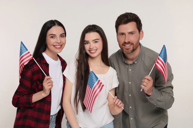 Photo of 4th of July - Independence Day of USA. Happy family with American flags on white background