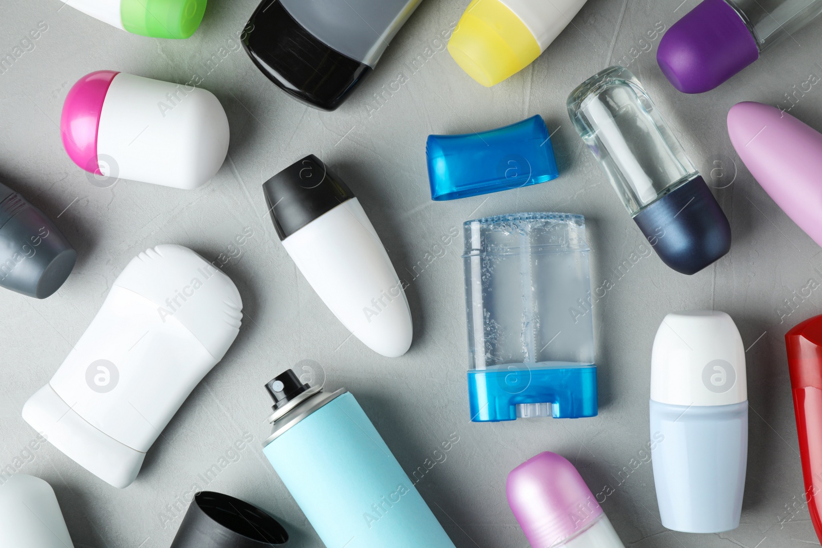 Photo of Flat lay composition with different natural deodorants on grey table