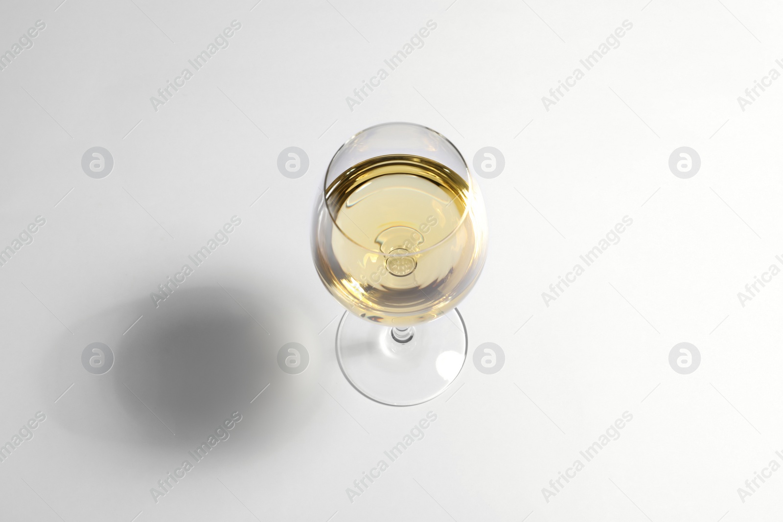 Photo of Glass of wine on white background, above view