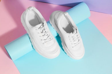 Photo of Pair of stylish sneakers on color background