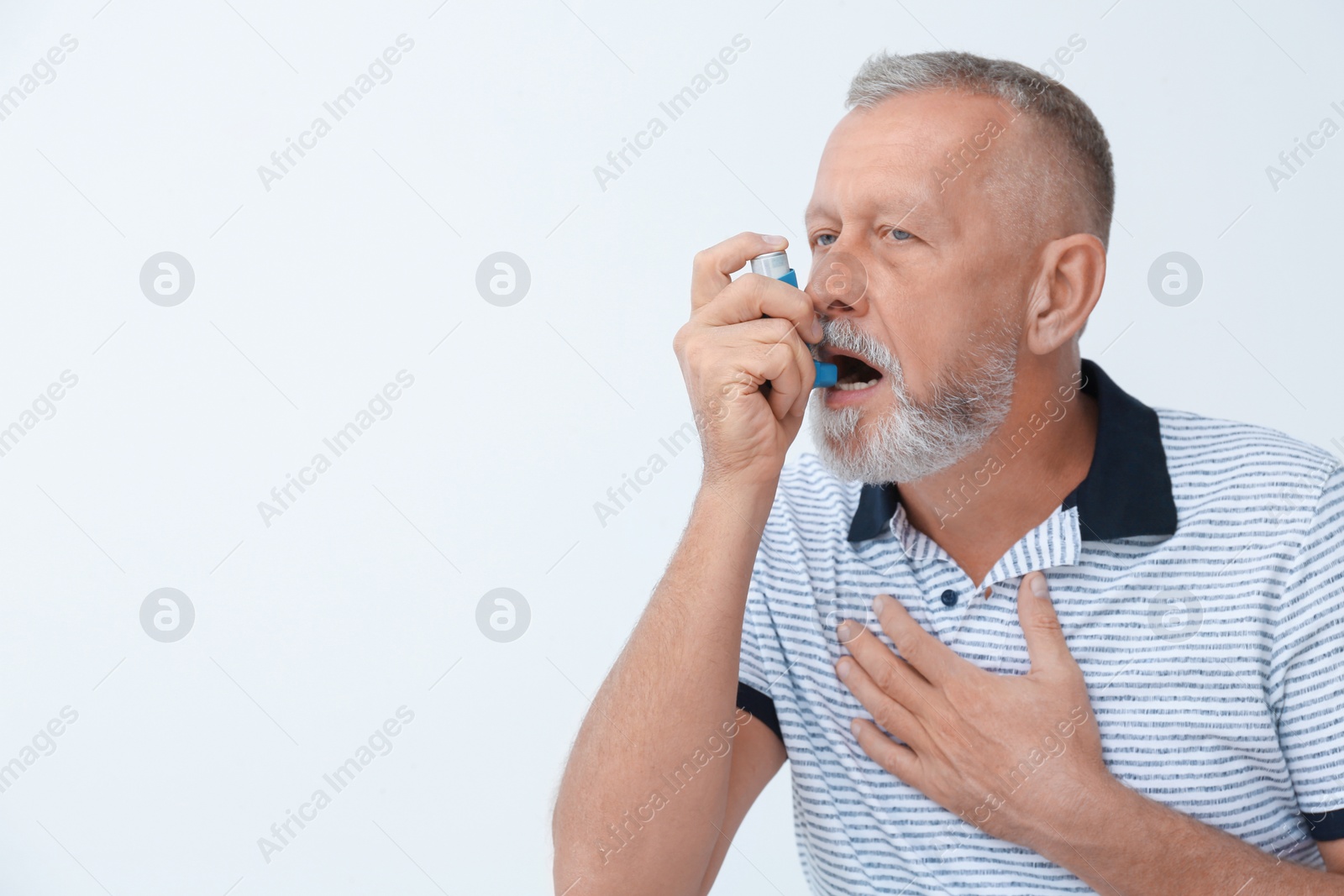 Photo of Man using asthma inhaler on white background