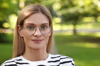 Photo of Portrait of confident female entrepreneur outdoors. Beautiful woman with glasses in park. Space for text