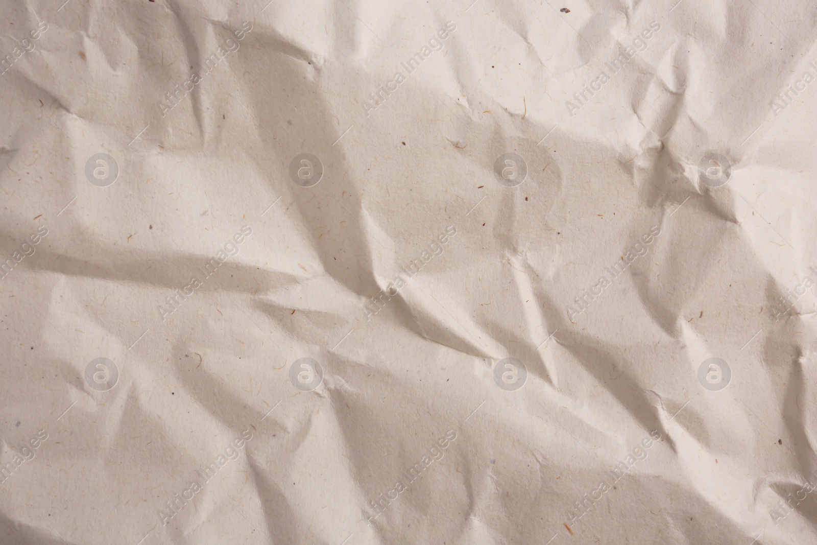 Photo of Texture of crumpled parchment paper as background, top view