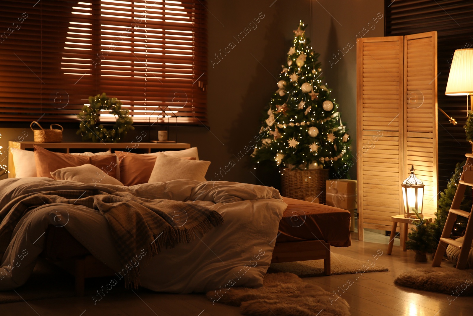 Photo of Decorated Christmas tree in festive bedroom interior