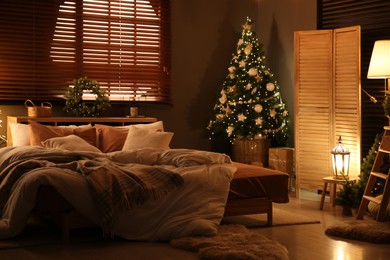 Decorated Christmas tree in festive bedroom interior