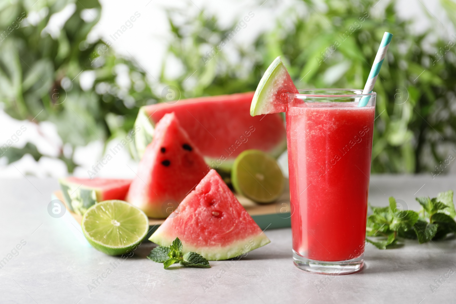 Photo of Tasty summer watermelon drink in glass and fresh fruits on table