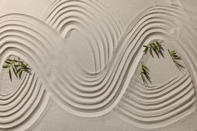 Beautiful lines and branches on sand, top view. Zen garden