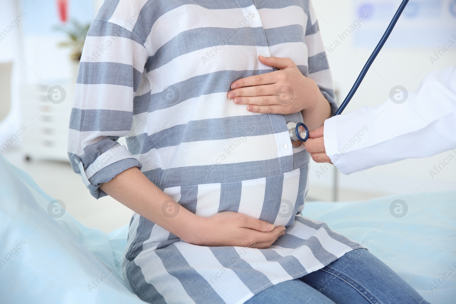 Photo of Gynecology consultation. Pregnant woman with her doctor in clinic