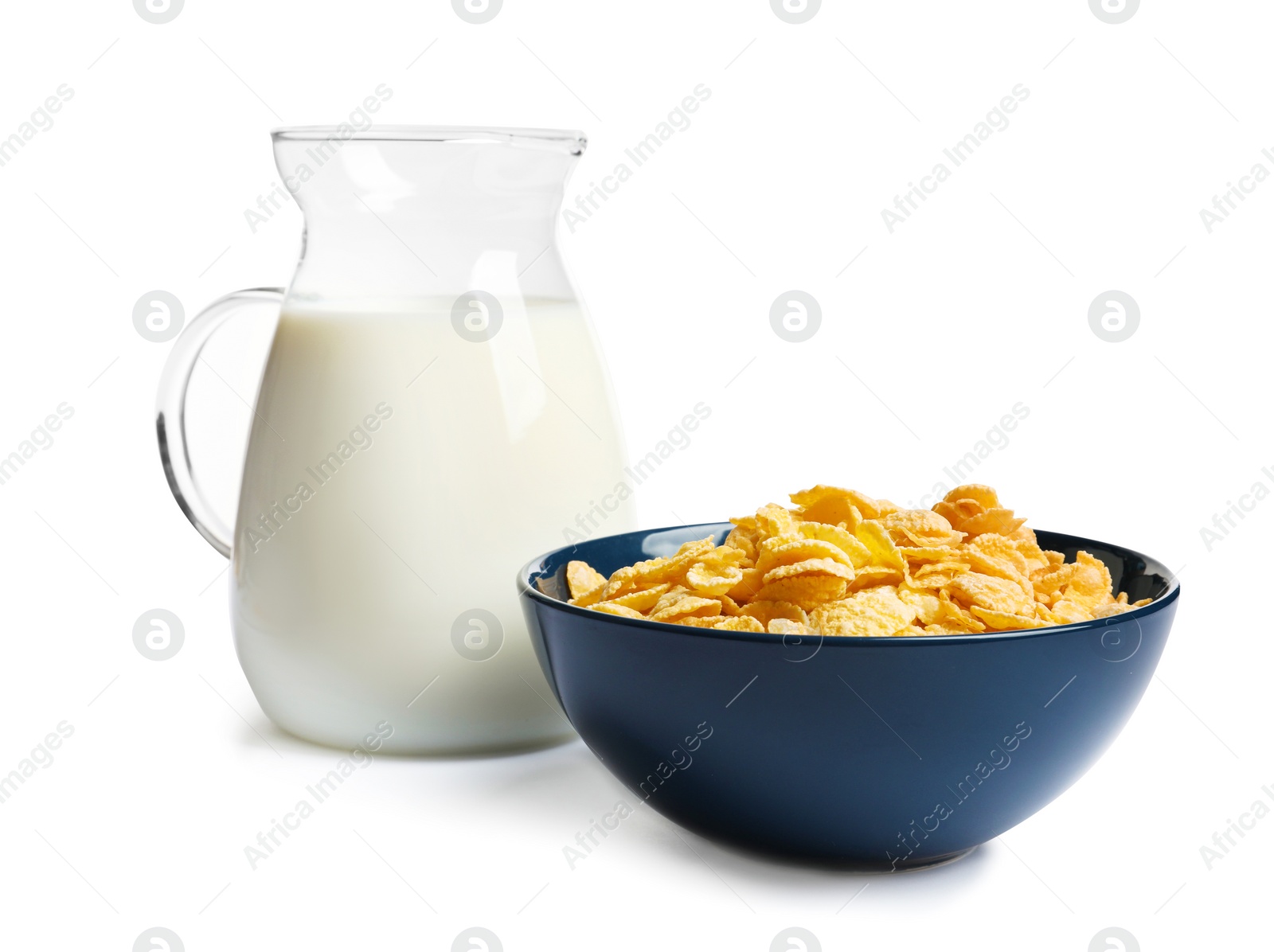 Photo of Bowl with crispy cornflakes and jug of milk on white background