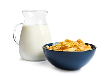 Photo of Bowl with crispy cornflakes and jug of milk on white background