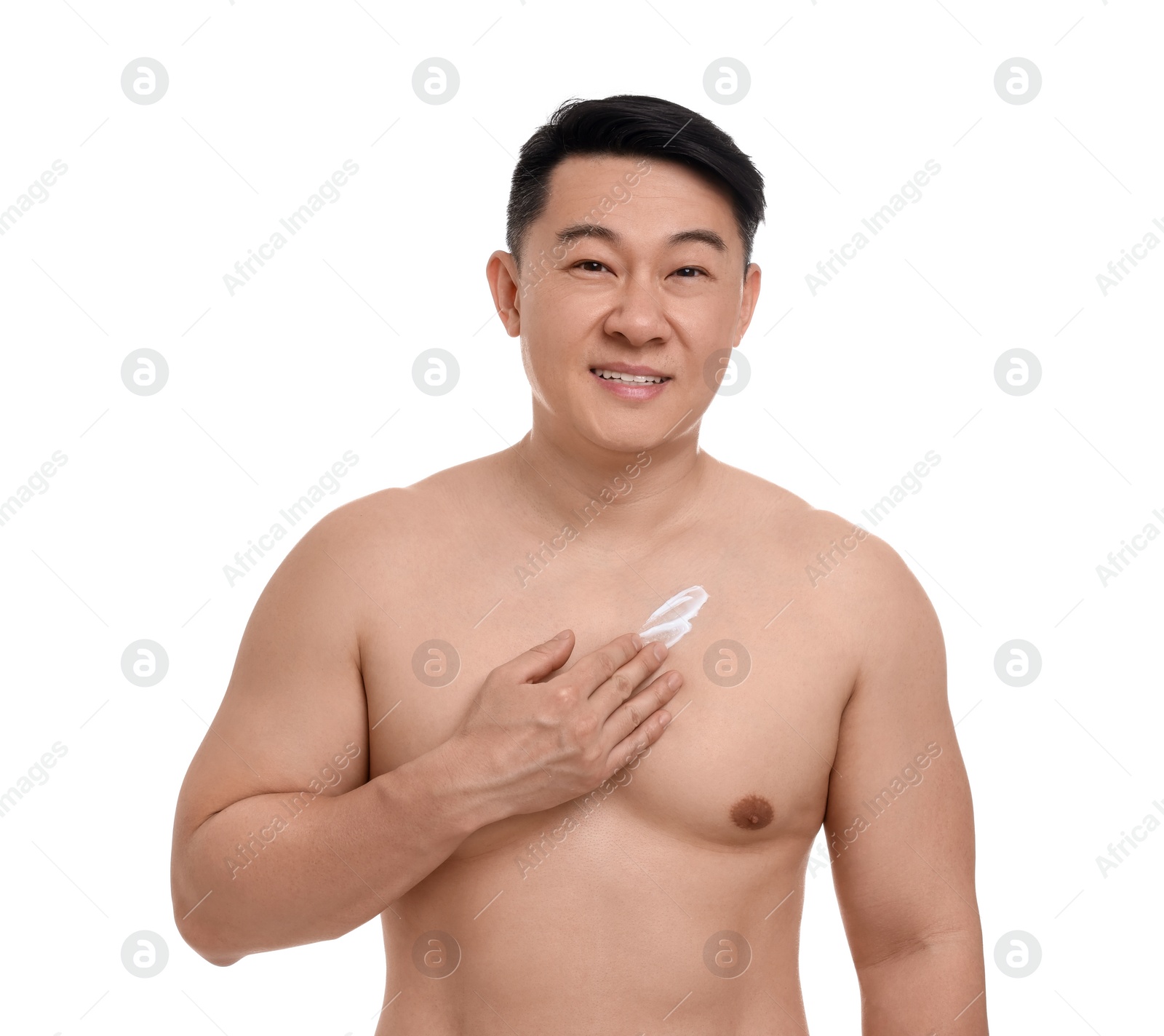 Photo of Handsome man applying body cream onto his chest on white background