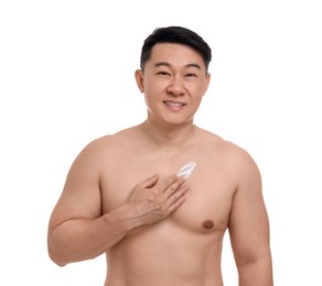 Handsome man applying body cream onto his chest on white background