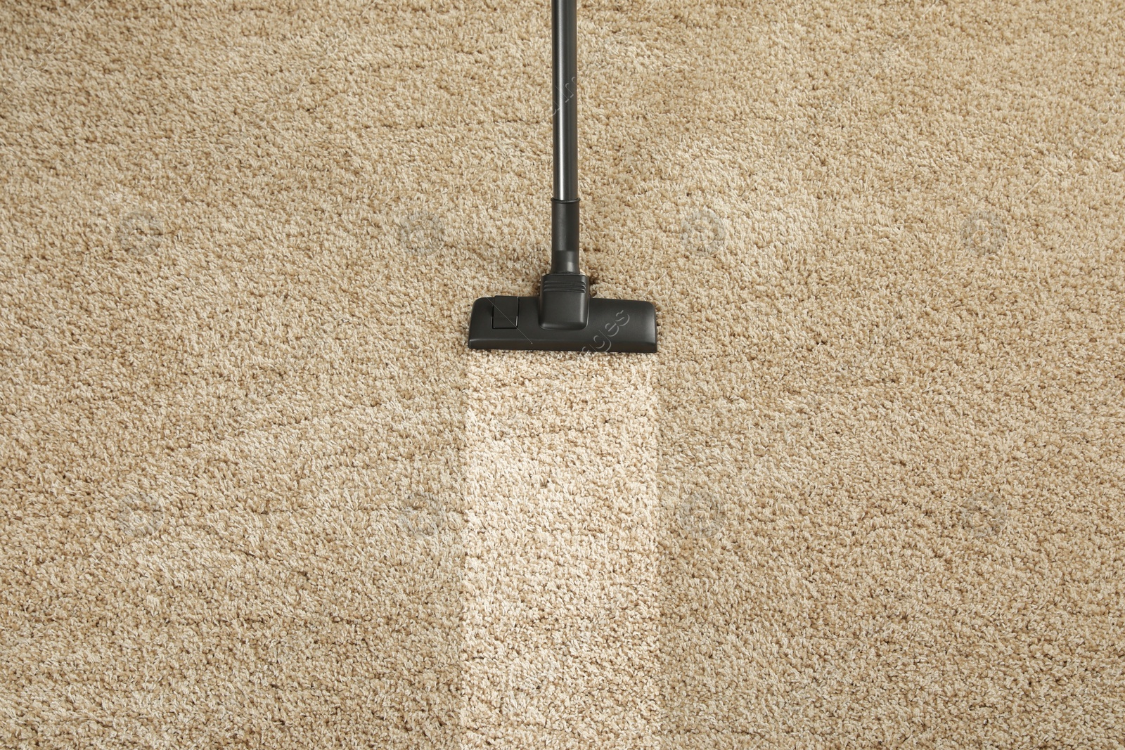 Image of Hoovering carpet with vacuum cleaner, above view and space for text. Clean trace on dirty surface